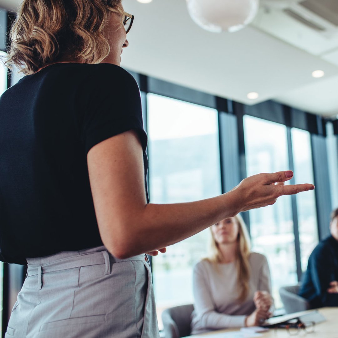 Woman presenting to a board